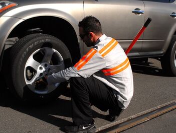 A picture of a man changing a tire in Bell Gardens California.