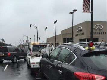 A picture of a tow truck hauling an SUV. 